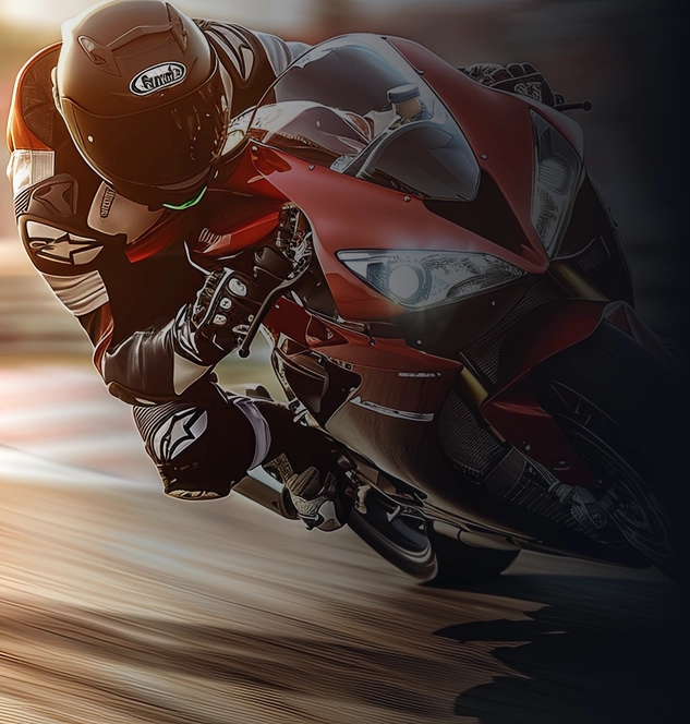 Pilote de moto de course professionnel s'inclinant fortement dans un virage à grande vitesse sur une piste.